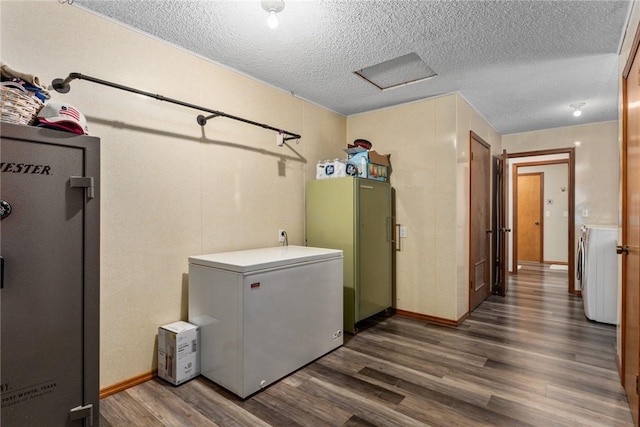 18058 E 1545th Ave, Teutopolis, IL 62467 - washroom with dark wood-style floors, a textured ceiling, washer / dryer, and water heater