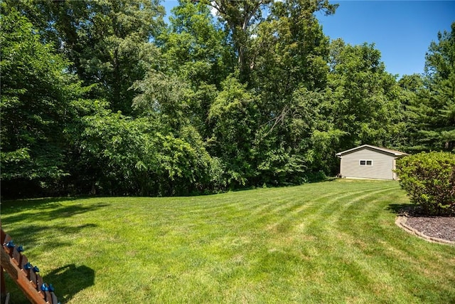 18058 E 1545th Ave, Teutopolis, IL 62467 - view of green lawn featuring a forest view and an outbuilding