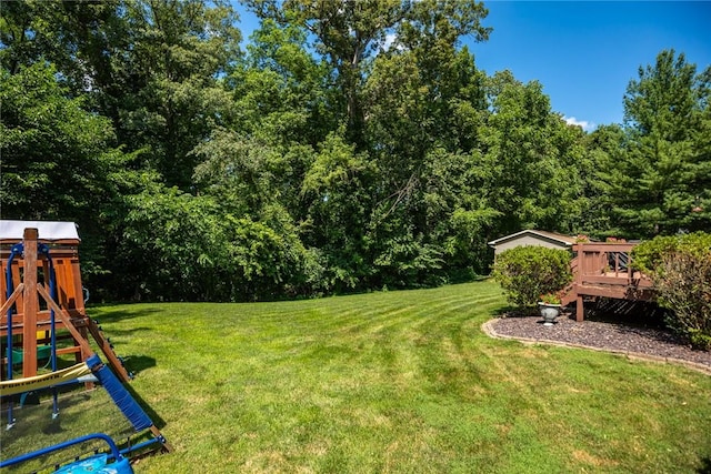 18058 E 1545th Ave, Teutopolis, IL 62467 - view of grassy yard featuring a playground, a wooden deck, and a forest view