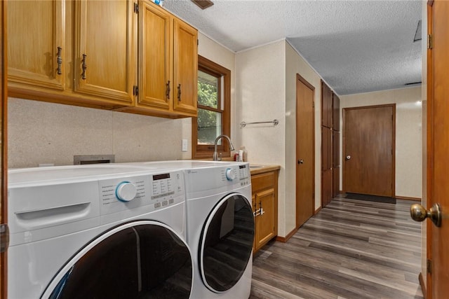 18058 E 1545th Ave, Teutopolis, IL 62467 - washroom with a textured ceiling, washer and dryer, dark wood finished floors, and cabinet space