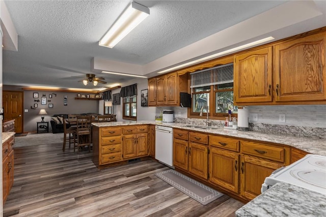 18058 E 1545th Ave, Teutopolis, IL 62467 - kitchen featuring white appliances, a peninsula, a textured ceiling, brown cabinetry, and ceiling fan