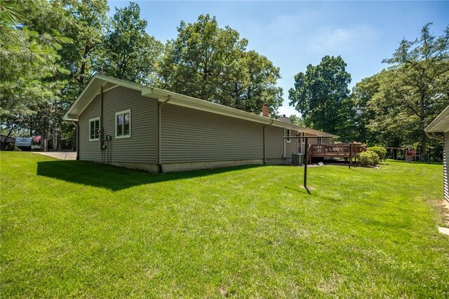 18058 E 1545th Ave, Teutopolis, IL 62467 - view of home's exterior with a deck and a yard