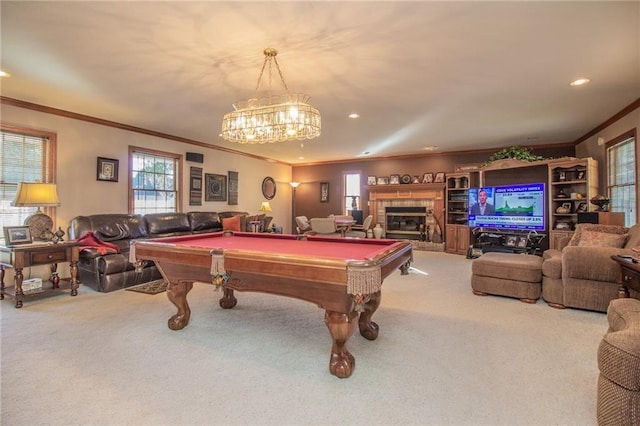 recreation room featuring recessed lighting, a glass covered fireplace, ornamental molding, and carpet flooring