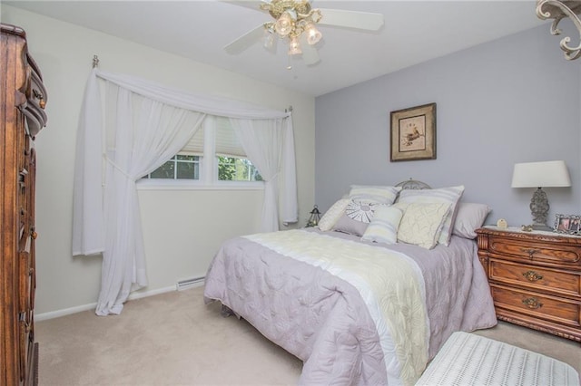 bedroom featuring a baseboard heating unit, baseboards, light colored carpet, and ceiling fan