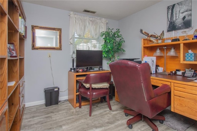 office area featuring visible vents, baseboards, and wood finished floors