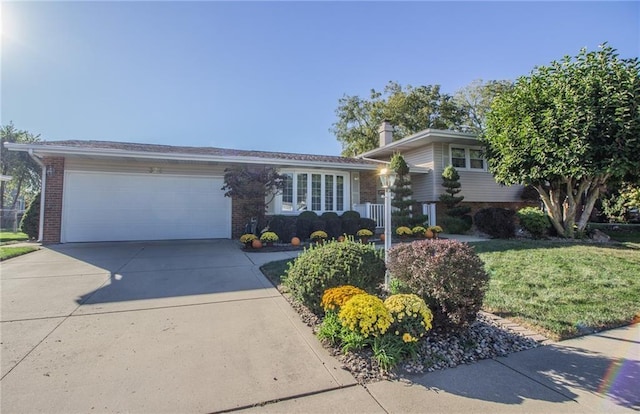 tri-level home with a garage, brick siding, concrete driveway, and a front yard