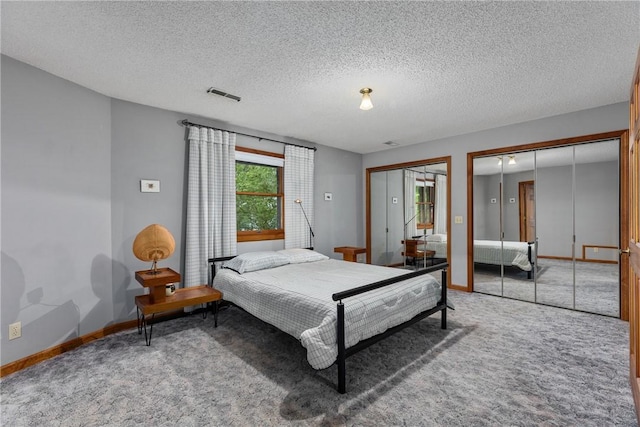 14915 N 8th Ave, Effingham, IL 62401 - bedroom featuring multiple closets, carpet floors, and a textured ceiling