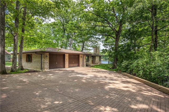14915 N 8th Ave, Effingham, IL 62401 - ranch-style home featuring driveway, a chimney, brick siding, and a garage