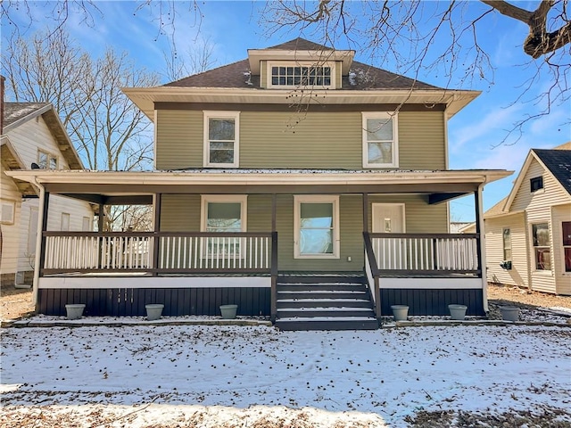 american foursquare style home featuring a porch