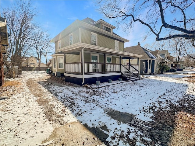 american foursquare style home with a residential view and a porch