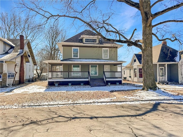 american foursquare style home featuring a porch