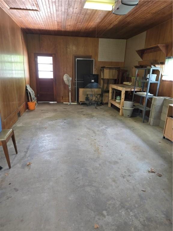 9 Orchard Dr, Charleston, IL 61920 - garage with wood ceiling, a garage door opener, and wood walls