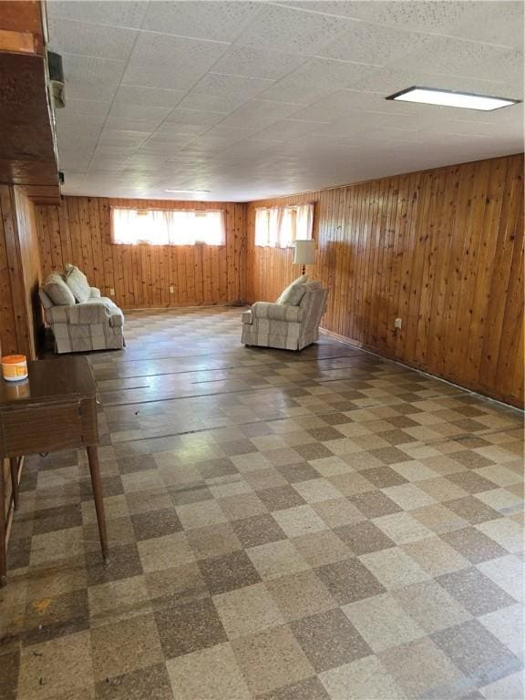 9 Orchard Dr, Charleston, IL 61920 - unfurnished living room with tile patterned floors and wood walls