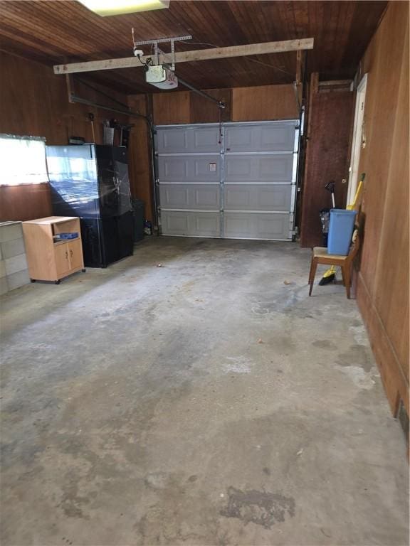 9 Orchard Dr, Charleston, IL 61920 - garage featuring wood walls, a garage door opener, and wooden ceiling