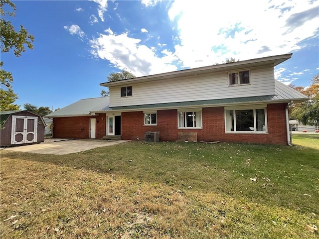 1408 Hickory Hill Dr, Effingham, IL 62401 - rear view of house featuring a patio area, brick siding, cooling unit, and metal roof