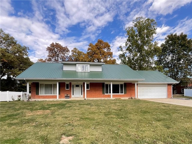 1408 Hickory Hill Dr, Effingham, IL 62401 - view of front of house with brick siding, an attached garage, driveway, metal roof, and a porch