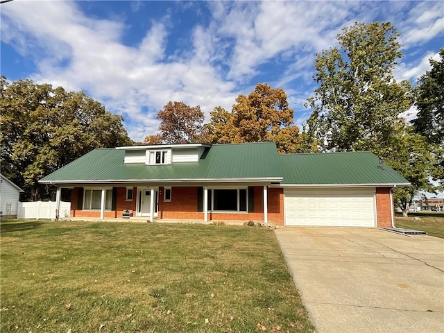 view of front facade with a front lawn, covered porch, and a garage