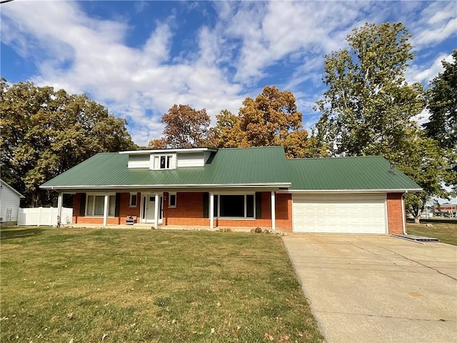 1408 Hickory Hill Dr, Effingham, IL 62401 - view of front of home featuring brick siding, an attached garage, concrete driveway, and metal roof