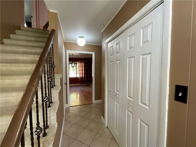 1408 Hickory Hill Dr, Effingham, IL 62401 - hall featuring crown molding, light tile patterned floors, stairway, a chandelier, and baseboards