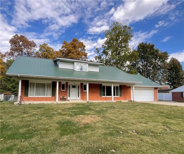 view of front of property with covered porch, a garage, and a front lawn