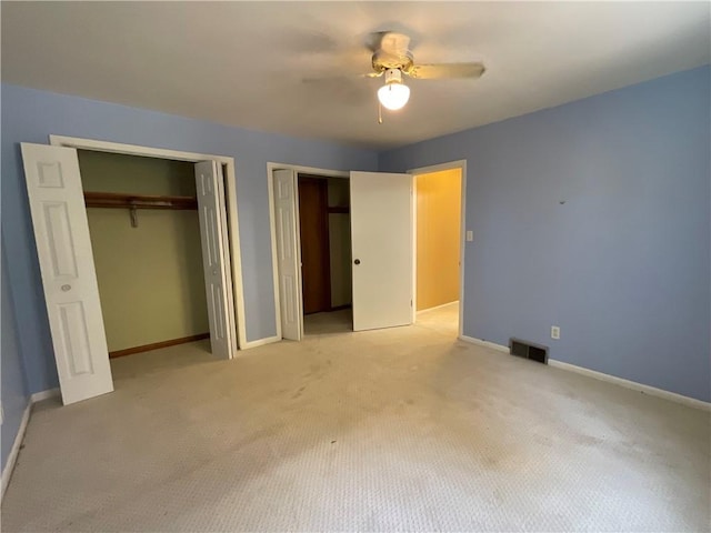 1408 Hickory Hill Dr, Effingham, IL 62401 - unfurnished bedroom featuring multiple closets, light colored carpet, baseboards, and a ceiling fan