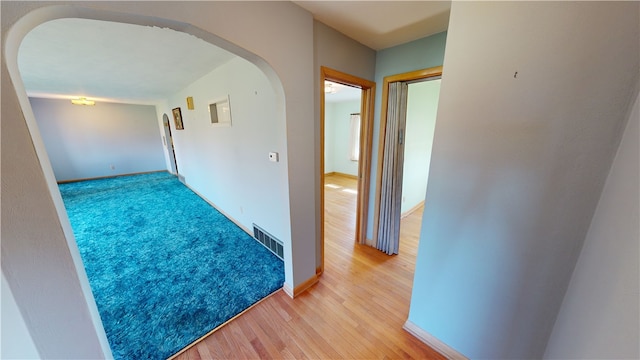 hallway with light hardwood / wood-style flooring