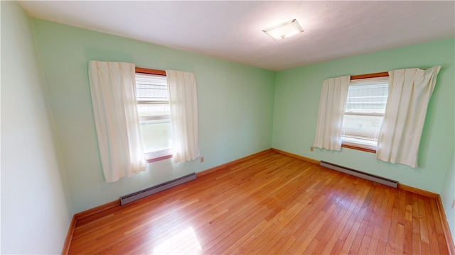 spare room with light hardwood / wood-style floors and a baseboard radiator