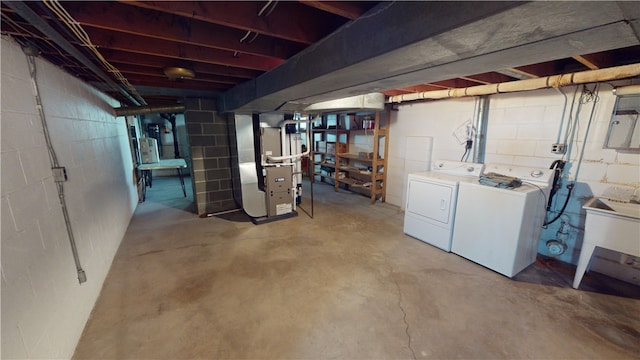 basement featuring washer and dryer and heating unit