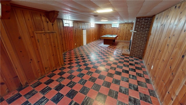 basement with wooden walls and billiards