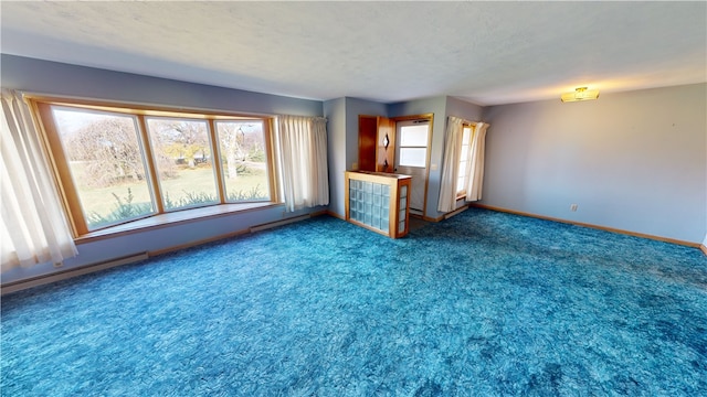 unfurnished living room with carpet and a textured ceiling