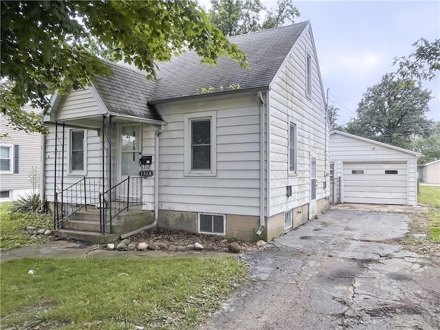 1710 11th St, Charleston, IL 61920 - view of front of home featuring a shingled roof, a garage, driveway, and an outdoor structure