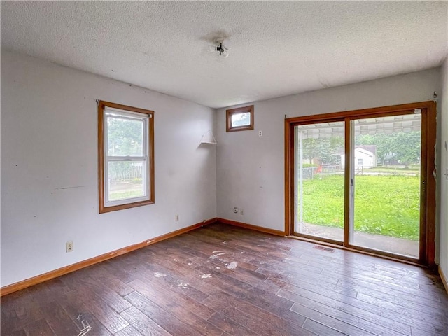 1710 11th St, Charleston, IL 61920 - empty room with a textured ceiling and hardwood / wood-style flooring