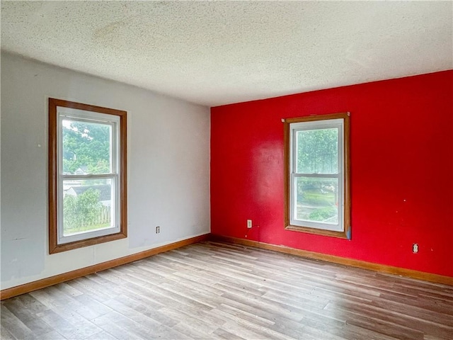 1710 11th St, Charleston, IL 61920 - unfurnished room featuring wood finished floors and a textured ceiling