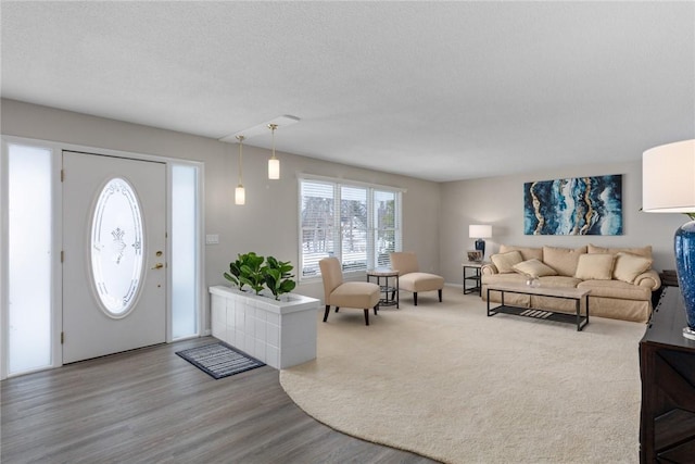 entrance foyer with a textured ceiling and wood finished floors