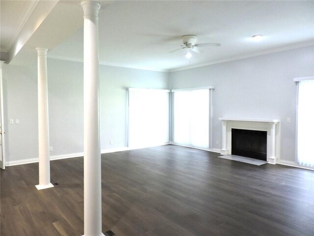 37626 Hunnington Ridge Rd, Hoopeston, IL 60942 - unfurnished living room featuring a ceiling fan, decorative columns, crown molding, a fireplace with flush hearth, and dark wood-style flooring