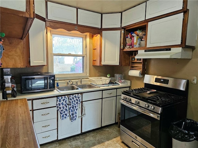 kitchen with sink, stainless steel gas range oven, and white cabinets