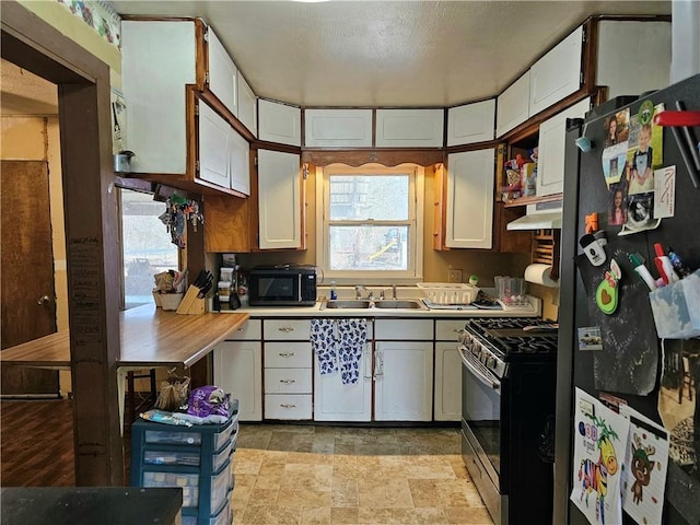 kitchen with white cabinetry, sink, and stainless steel appliances