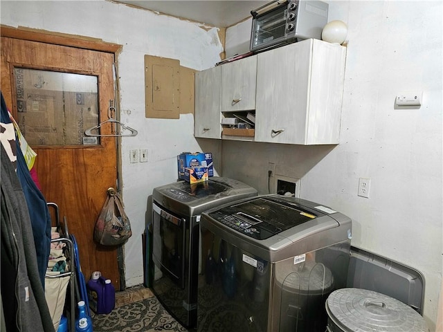 washroom with cabinets, separate washer and dryer, and electric panel