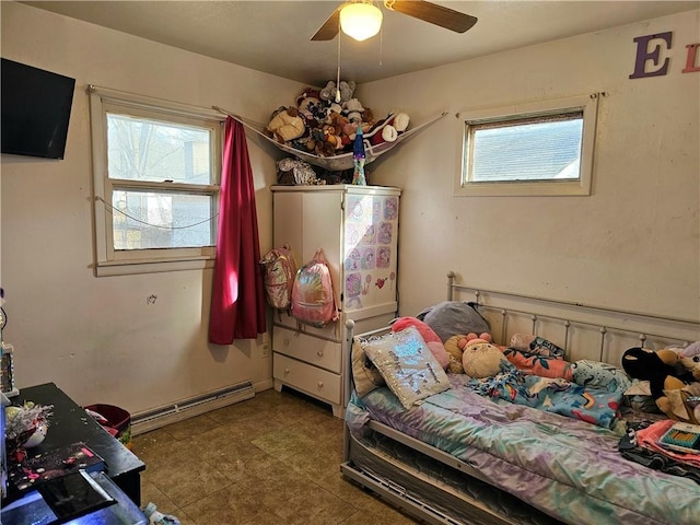 bedroom with multiple windows, a baseboard radiator, and ceiling fan