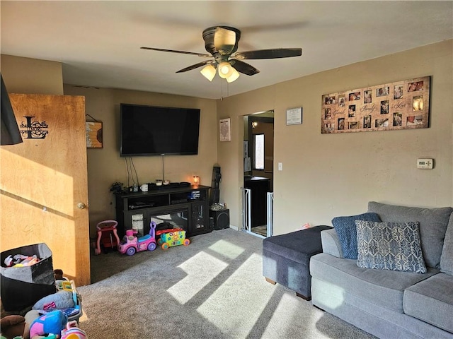 living room featuring ceiling fan and carpet floors