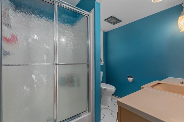 full bathroom with an enclosed shower, toilet, a sink, and tile patterned floors