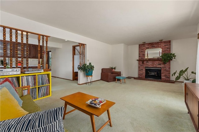 living area featuring light colored carpet, a brick fireplace, and baseboards