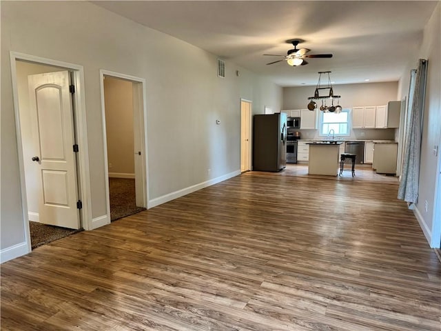 2421 Charleston Ave, Mattoon, IL 61938 - unfurnished living room with a ceiling fan and dark wood-style floors