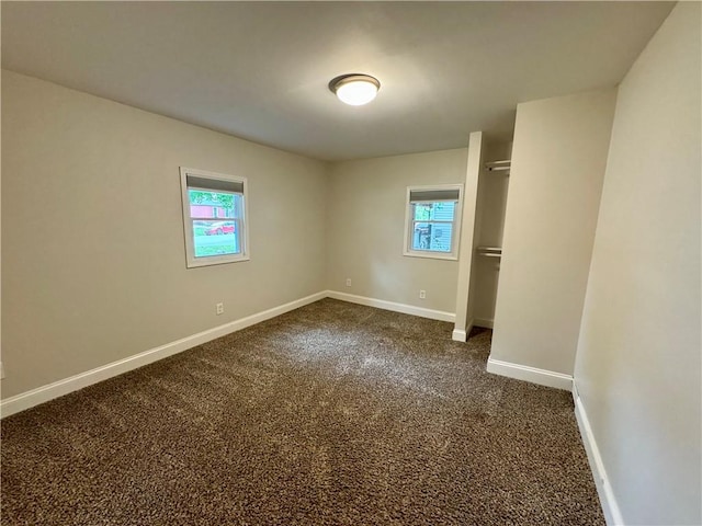 2421 Charleston Ave, Mattoon, IL 61938 - spare room featuring baseboards and dark colored carpet