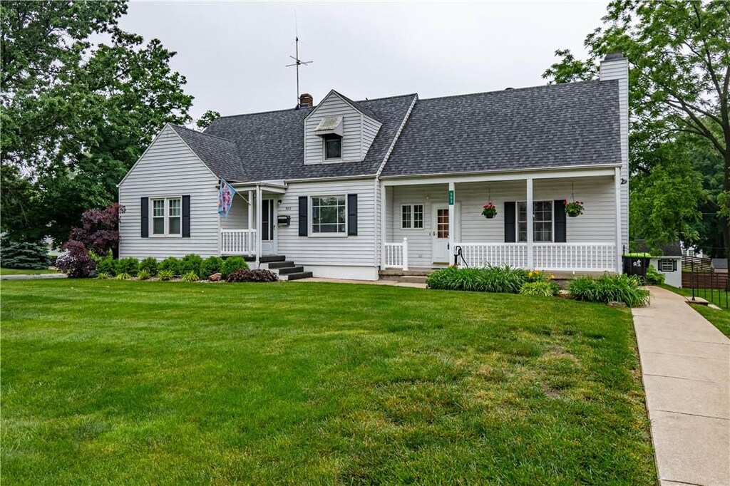 503 N 34th St, Decatur, IL 62521 - cape cod home with a chimney, a front yard, a shingled roof, and covered porch