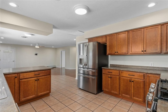 33 Homestead Dr, Newton, IL 62448 - kitchen with appliances with stainless steel finishes, brown cabinetry, light tile patterned floors, and recessed lighting