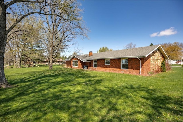 33 Homestead Dr, Newton, IL 62448 - view of front of house featuring a chimney, a front yard, brick siding, and a playground