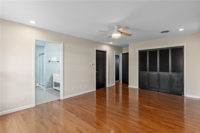 33 Homestead Dr, Newton, IL 62448 - unfurnished bedroom featuring light wood-style floors, baseboards, recessed lighting, ceiling fan, and ensuite bath