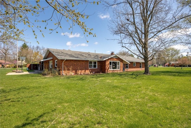33 Homestead Dr, Newton, IL 62448 - view of front facade featuring a front yard, brick siding, and a chimney