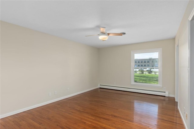 33 Homestead Dr, Newton, IL 62448 - empty room with baseboard heating, wood finished floors, ceiling fan, and baseboards